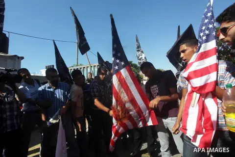 Palestinians burn the U.S. flag during a protest in front of the United Nations headquarters in Gaza city against the showing of a movie that is allegedly offensive to Muslim Prophet Mohammad, Sept 12, 2012. Photo by Ash...