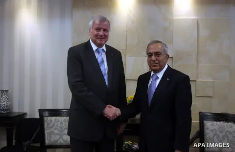 Palestinian Prime Minister Salam Fayyad, right, shakes hands with visiting Bavarian Prime Minister Horst Seehofer during a meeting in the West Bank city of Ramallah, Sept. 11, 2012. Photo by Issam Rimawi