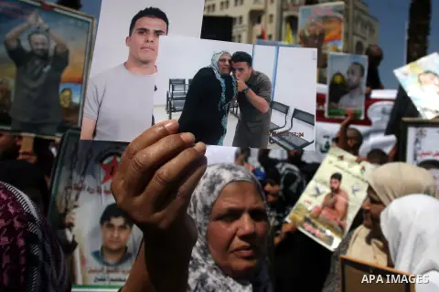 Palestinians hold portraits of their relatives held in Israeli jails during a protest calling for their release, in the West Bank city of Ramallah, Sept. 13, 2012. Photo by Issam Rimawi