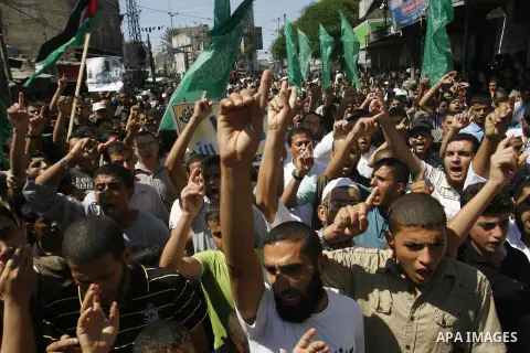 Palestinians hold placards as they shout anti-U.S. slogans during a demonstration against the controversial film 'Innocence of Muslims' in Rafah southern Gaza strip, on September 14, 2012. The controversial low budget fi...