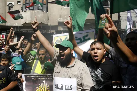 Palestinians hold placards as they shout anti-U.S. slogans during a demonstration against the controversial film 'Innocence of Muslims' in Rafah southern Gaza strip, on September 14, 2012. The controversial low budget fi...