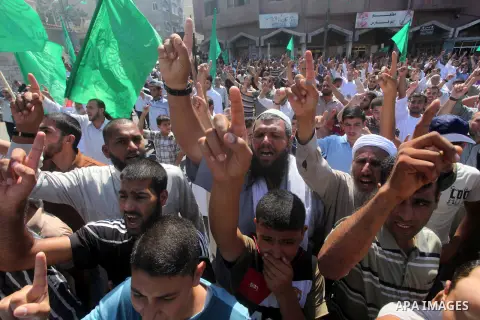 Palestinians hold placards as they shout anti-U.S. slogans during a demonstration against the controversial film 'Innocence of Muslims' in Khan Younis southern Gaza strip, on September 14, 2012. The controversial low bud...
