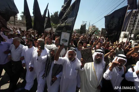Palestinians hold placards as they shout anti-U.S. slogans during a demonstration against the controversial film 'Innocence of Muslims' in Khan Younis southern Gaza strip, on September 14, 2012. The controversial low bud...