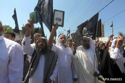 Palestinians hold placards as they shout anti-U.S. slogans during a demonstration against the controversial film 'Innocence of Muslims' in Khan Younis southern Gaza strip, on September 14, 2012. The controversial low bud...