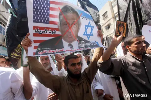 Palestinians hold placards as they shout anti-U.S. slogans during a demonstration against the controversial film 'Innocence of Muslims' in Khan Younis southern Gaza strip, on September 14, 2012. The controversial low bud...
