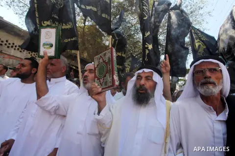 Palestinians hold placards as they shout anti-U.S. slogans during a demonstration against the controversial film 'Innocence of Muslims' in Khan Younis southern Gaza strip, on September 14, 2012. The controversial low bud...