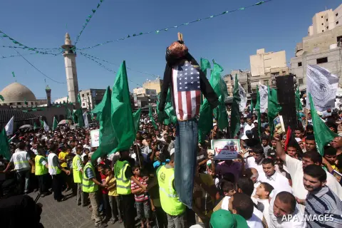 Palestinians hold placards as they shout anti-U.S. slogans during a demonstration against the controversial film 'Innocence of Muslims' in Khan Younis southern Gaza strip, on September 14, 2012. The controversial low bud...