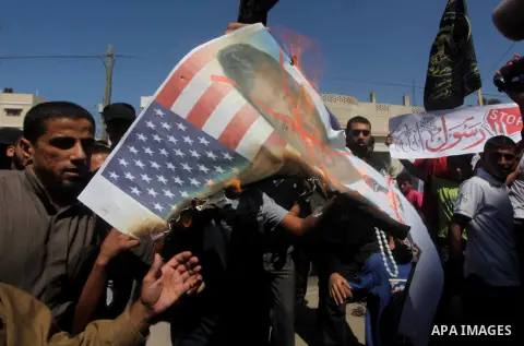 Palestinians burn a portrait of the director of controversial film 'Innocence of Muslims' during a demonstration in Khan Younis southern Gaza strip, on September 14, 2012. The controversial low budget film reportedly mad...