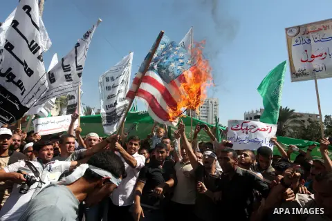 Palestinians burn the U.S. flags during a demonstration against the controversial film 'Innocence of Muslims' in Gaza city, on September 14, 2012. The controversial low budget film reportedly made by an Israeli-American...