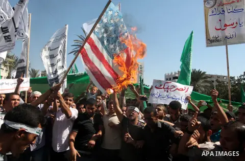 Palestinians burn the U.S. flags during a demonstration against the controversial film 'Innocence of Muslims' in Gaza city, on September 14, 2012. The controversial low budget film reportedly made by an Israeli-American...