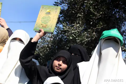 A Palestinian girl holds holy Qur'an during a demonstration against the controversial film 'Innocence of Muslims' in Gaza City, on September 14, 2012. The controversial low budget film reportedly made by an Israeli-Ameri...