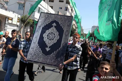 A Palestinian man stands near the U.S. flag toy during a demonstration against the controversial film 'Innocence of Muslims' in Gaza city, on September 14, 2012. The controversial low budget film reportedly made by an Is...