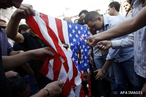 Palestinians burn the U.S. flag during a demonstration against the controversial film 'Innocence of Muslims' in the West Bank city of Nablus, on September 14, 2012. The controversial low budget film reportedly made by an...