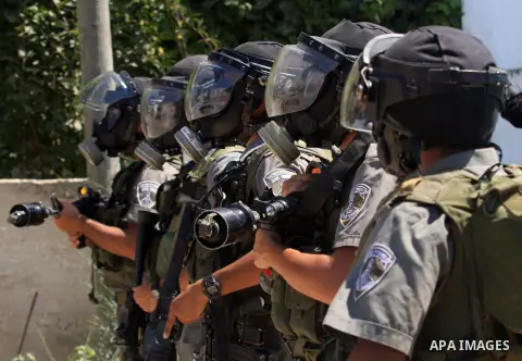 Israeli border police stand guards during a demonstration against the expropriation of Palestinian land by Israel in the village of Kafr Qaddum, near the West Bank city of Nablus, on Sept. 14, 2012. Photo by Nedal Eshtay...