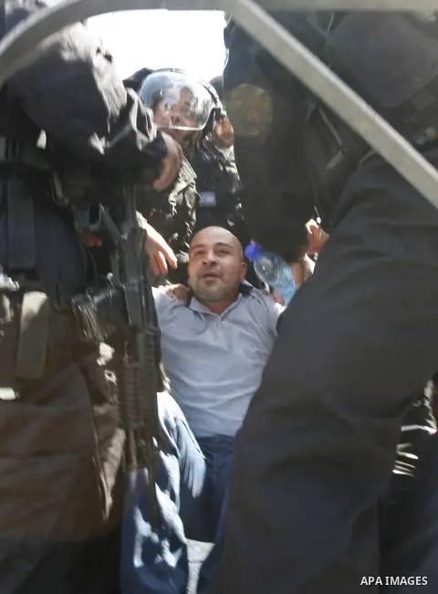 Israeli policemen detain a Palestinian protester during a demonstration against the controversial film 'Innocence of Muslims' in front of al-Aqsa Mosqe in Jerusalem, on September 14, 2012. The controversial low budget fi...
