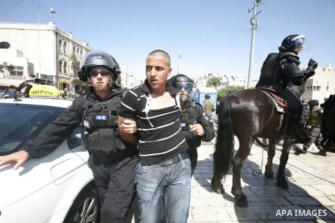 Israeli policemen detain a Palestinian protester during a demonstration against the controversial film 'Innocence of Muslims' in front of al-Aqsa Mosqe in Jerusalem, on September 14, 2012. The controversial low budget fi...
