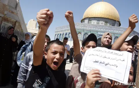 Palestinians shout slogans during a demonstration against the controversial film 'Innocence of Muslims' in front of al-Aqsa Mosqe in Jerusalem, on September 14, 2012. The controversial low budget film reportedly made by...