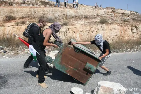 Palestinians make a road barricade during a protest against the confiscation of Palestinian land to expand Jewish settlements in the West Bank village of Nabi Saleh near Ramallah on September 14, 2012.The weekly demonstr...