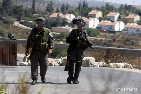 Israeli soldiers fire tear gas at Palestinians during a protest against the confiscation of Palestinian land to expand Jewish settlements in the West Bank village of Nabi Saleh near Ramallah on September 14, 2012.The wee...