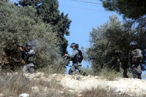 Israeli soldiers fire tear gas at Palestinians during a protest against the confiscation of Palestinian land to expand Jewish settlements in the West Bank village of Nabi Saleh near Ramallah on September 14, 2012.The wee...