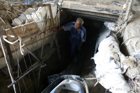A Palestinian man works inside a tunnel used for smuggling goods, including food, fuel and building materials, along the Gaza-Egypt border in Rafah, in the southern Gaza Strip, on Sept. 15, 2012. The smuggling tunnels un...