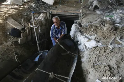 A Palestinian man works inside a tunnel used for smuggling goods, including food, fuel and building materials, along the Gaza-Egypt border in Rafah, in the southern Gaza Strip, on Sept. 15, 2012. The smuggling tunnels un...