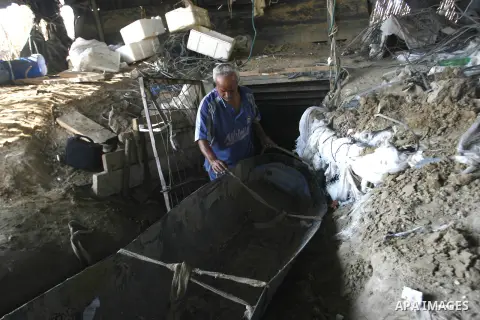 A Palestinian man works inside a tunnel used for smuggling goods, including food, fuel and building materials, along the Gaza-Egypt border in Rafah, in the southern Gaza Strip, on Sept. 15, 2012. The smuggling tunnels un...
