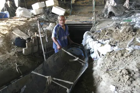 A Palestinian man works inside a tunnel used for smuggling goods, including food, fuel and building materials, along the Gaza-Egypt border in Rafah, in the southern Gaza Strip, on Sept. 15, 2012. The smuggling tunnels un...