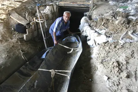 A Palestinian man works inside a tunnel used for smuggling goods, including food, fuel and building materials, along the Gaza-Egypt border in Rafah, in the southern Gaza Strip, on Sept. 15, 2012. The smuggling tunnels un...