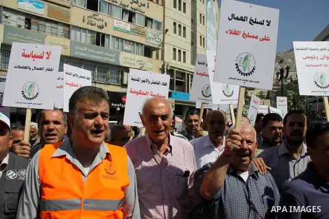 Palestinian protesters shout slogans during a demonstration against the high cost of living in the West Bank city of Nablus, Sept. 15, 2012. The Prime Minister pledged earlier that the Palestinian Authority will decrease...