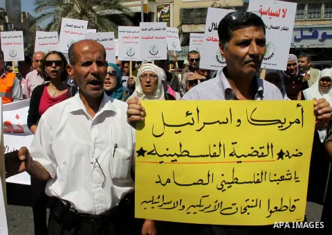 Palestinian protesters shout slogans during a demonstration against the high cost of living in the West Bank city of Nablus, Sept. 15, 2012. The Prime Minister pledged earlier that the Palestinian Authority will decrease...