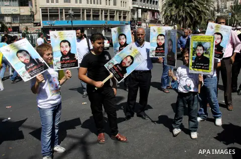 Palestinians take part in a protest calling for release of the Palestinian prisoner in Israeli jails Hasan al-Safadi who is still refusing food since 21 June 2012 , during a demonstration in support him, in the West Bank...