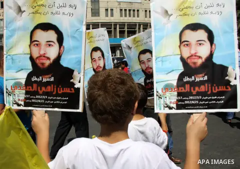 Palestinians take part in a protest calling for release of the Palestinian prisoner in Israeli jails Hasan al-Safadi who is still refusing food since 21 June 2012 , during a demonstration in support him, in the West Bank...