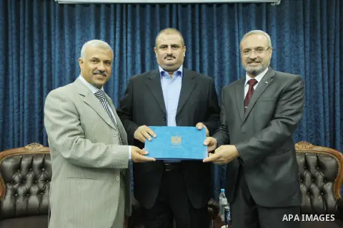 Secretary General of the Palestinian Cabinet in Gaza Strip, Abdel-Salam Siam receives the career duties in Gaza city on Sep. 16, 2012. Photo by Ahmed Shaat