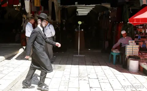 An ultra-Orthodox Jewish man walks at the market of Jerusalem's old city on Sept. 16, 2012. Photo by Mahfouz Abu Turk