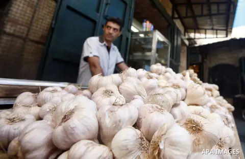 A Palestinian man sells garlic at the market of Jerusalem's old city on Sept. 16, 2012. Photo by Mahfouz Abu Turk