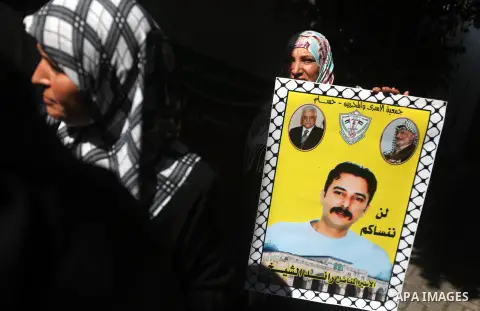 Palestinians hold a placard depicting jailed relatives during a protest in Gaza City calling for the release of Palestinian prisoners from Israeli jails September 17, 2012. Photo by Majdi Fathi