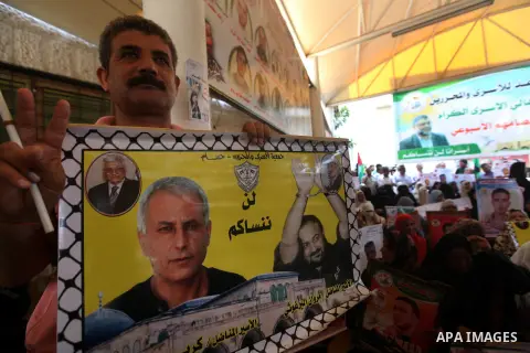 Palestinians hold a placard depicting jailed relatives during a protest in Gaza City calling for the release of Palestinian prisoners from Israeli jails September 17, 2012. Photo by Majdi Fathi