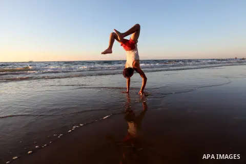 A Palestinian youth plays at the beach of Gaza city, Sept 17, 2012. Photo by Majdi Fathi