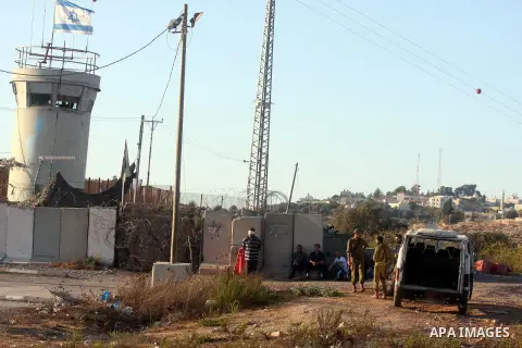 An Israeli soldier detains a Palestinian man on the Atara checkpoint in the West Bank city of Ramallah on September 17, 2012. Photo by Issam Rimawi