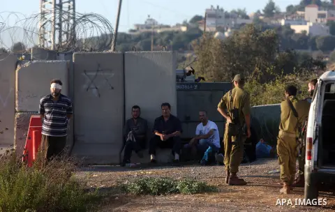 Israeli soldiers inspect a Palestinian car after detain the owner on the Atara checkpoint in the West Bank city of Ramallah on September 17, 2012. Photo by Issam Rimawi