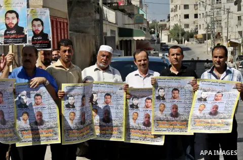 Palestinians participate a protest to calling for the liberty of Palestinians being held in Israeli jails, outside the Red Cross headquarters in the West Bank city of Nablus on September 18, 2012 . Photo by Nedal Eshtaya...