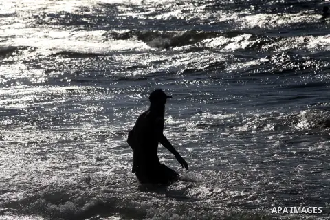 A Palestinian man enjoys swimming on the beach of Gaza city, Sept. 18, 2012 . Photo by Majdi Fathi