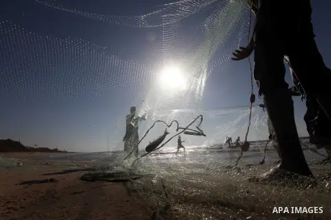 Palestinian fishers prepare to throw their trawl in the sea on the beach of Gaza city, Sept. 18, 2012 . Photo by Majdi Fathi