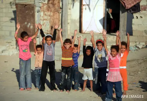 Palestinian children play in front of their house in Deir al-Balah in the central of Gaza strip, Sept. 18, 2012. Photo by Majdi Fathi