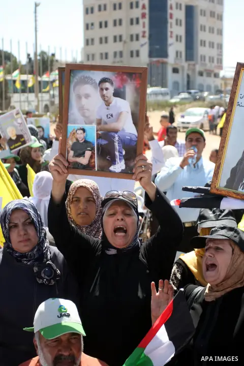 Palestinian women hold portraits of relatives held in Israeli jails during a protest to calling for their liberty, in the West Bank city of Ramallah on September 19, 2012. Photo by Issam Rimawi