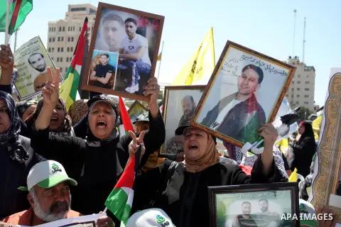 Palestinian women hold portraits of relatives held in Israeli jails during a protest to calling for their liberty, in the West Bank city of Ramallah on September 19, 2012. Photo by Issam Rimawi