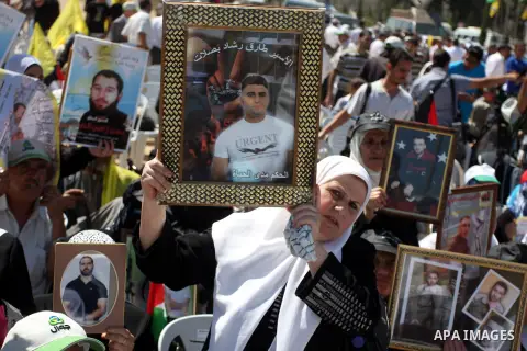 Palestinian women hold portraits of relatives held in Israeli jails during a protest to calling for their liberty, in the West Bank city of Ramallah on September 19, 2012. Photo by Issam Rimawi