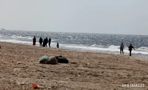 Palestinians walk at the beach of Deir al-Balah Palestinian refugee camp, central of Gaza Strip, on September 19, 2012. Photo by Majdi Fathi