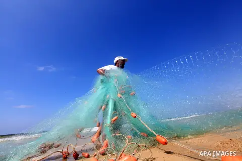 A Palestinian fisherman prepares his trawl for fishing at the sea front in Deir al-Balah Palestinian refugee camp, central of Gaza Strip, on September 19, 2012. Photo by Majdi Fathi